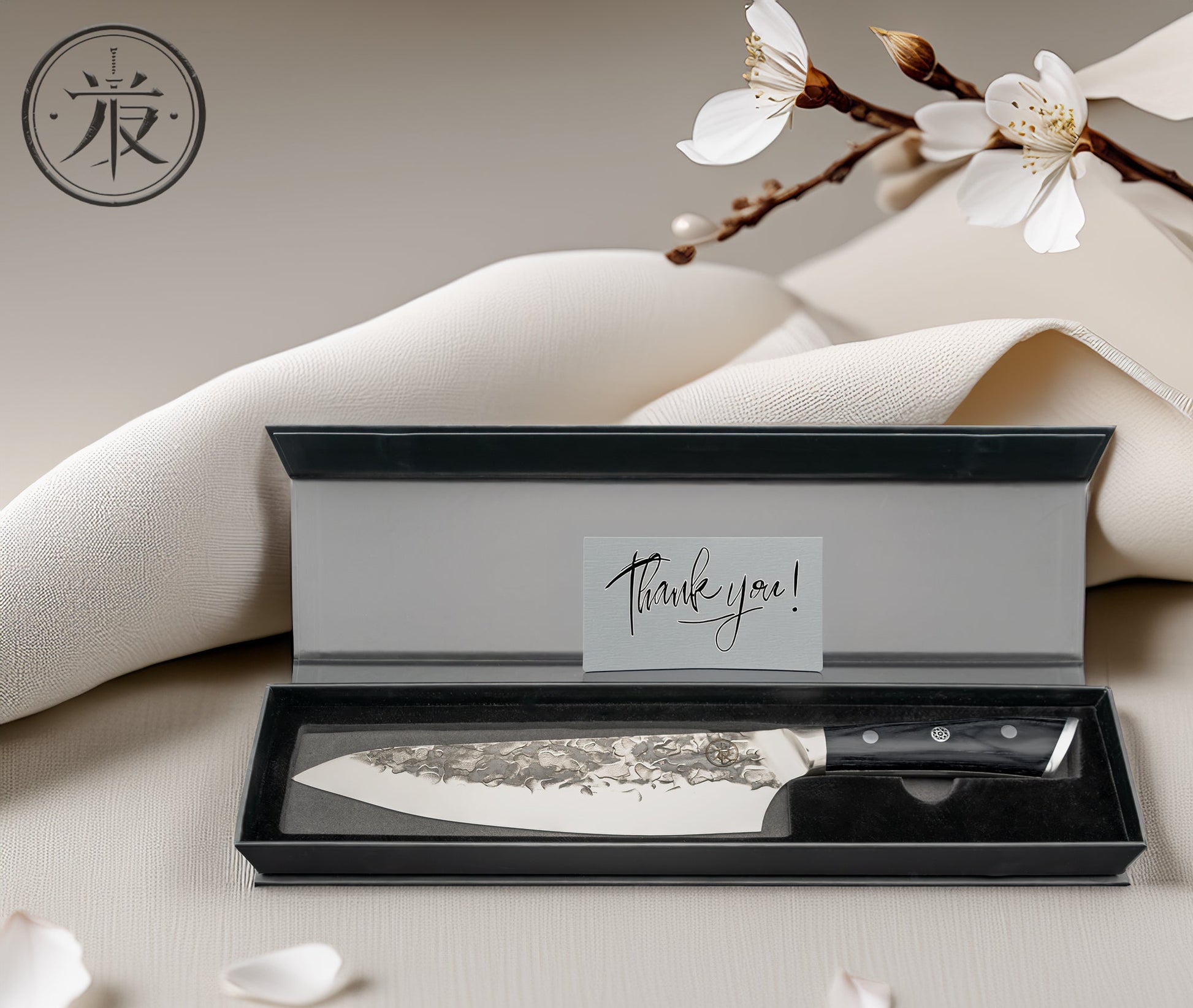 KOKORO Blade Heritage Edition Japanese chef knife with hammered steel finish and KuroWood handle, displayed on whitewashed wooden surface with red chopsticks, cherry blossom, and peppercorns – handcrafted precision and traditional Japanese aesthetics.